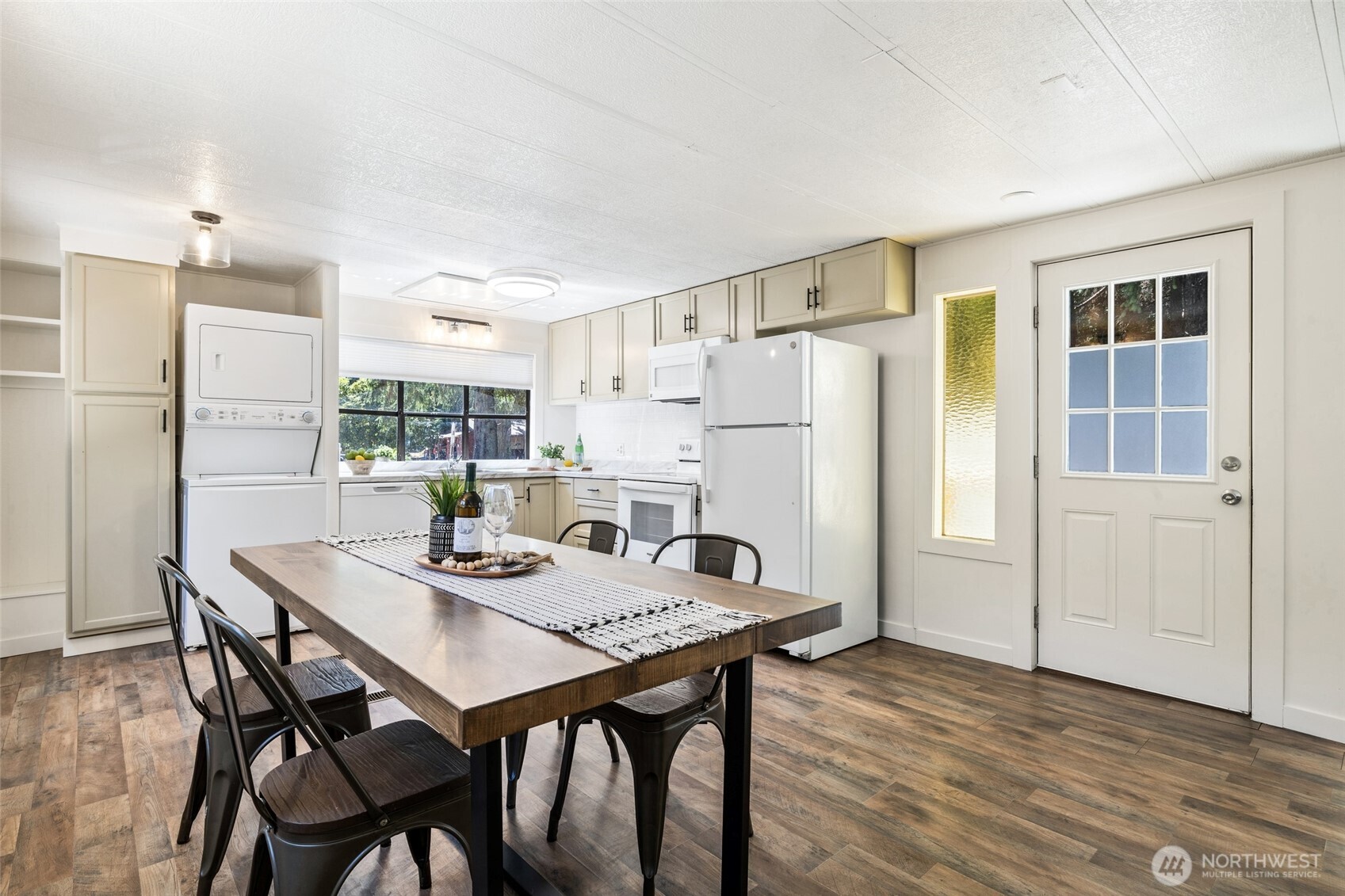 1527 East Roy Road Freeland, WA 98249 - Photo 5 of 24 a kitchen with a table chairs and refrigerator