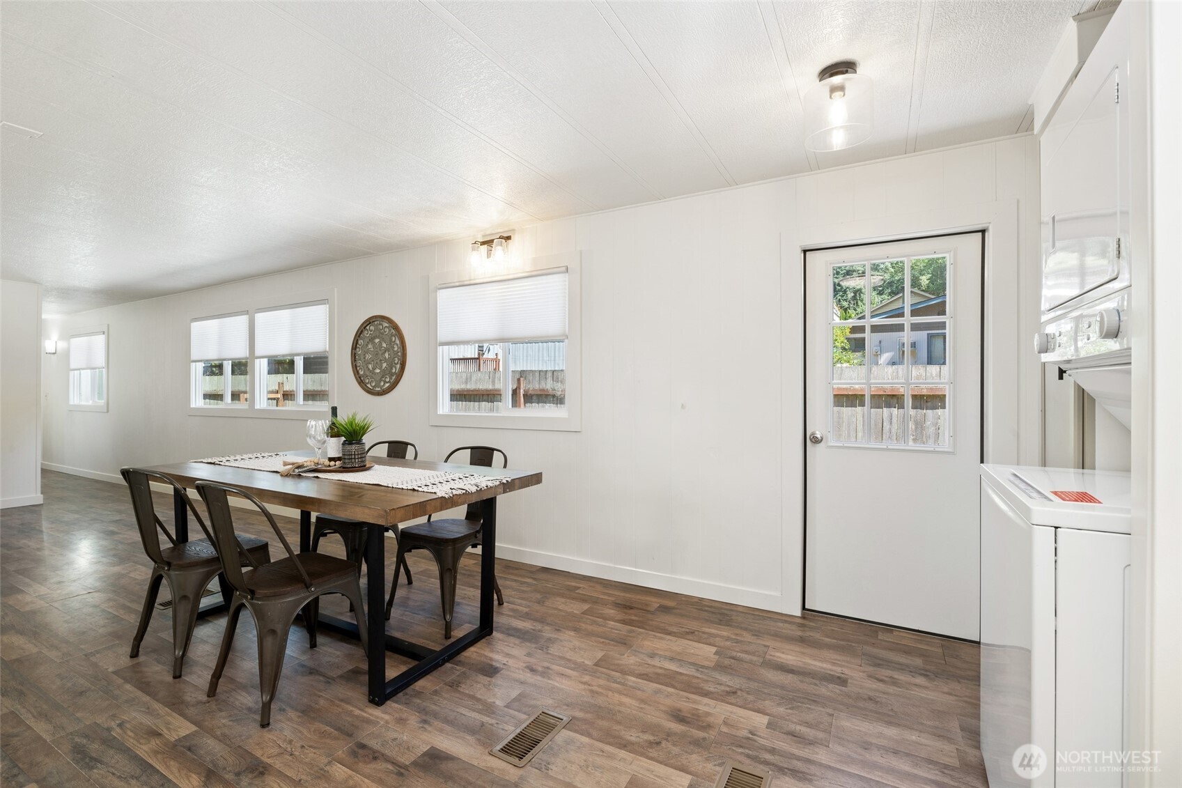 1527 East Roy Road Freeland, WA 98249 - Photo 7 of 24 a view of a dining room with furniture and wooden floor