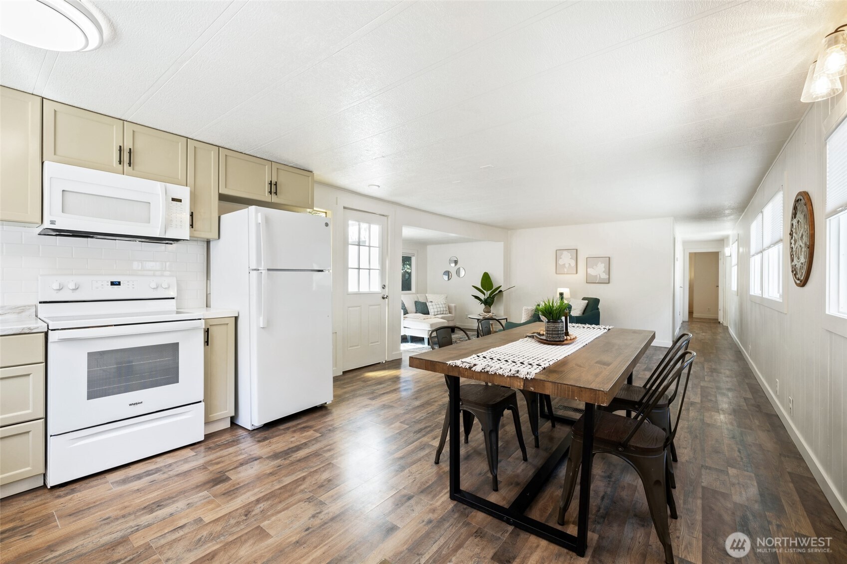 1527 East Roy Road Freeland, WA 98249 - Photo 8 of 24 a kitchen with white cabinets and stainless steel appliances