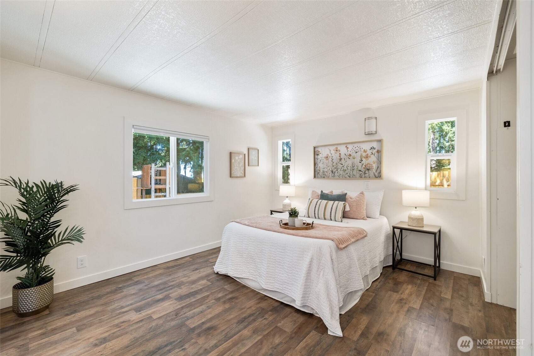 1527 East Roy Road Freeland, WA 98249 - Photo 10 of 24 a bedroom with a bed and a potted plant