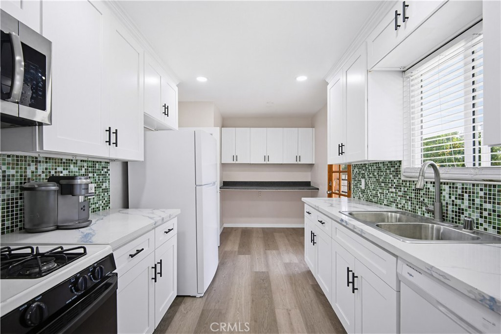 9805 Devon Street Rancho Cucamonga, CA 91730 - Photo 11 of 31 a kitchen with granite countertop a sink stove and refrigerator