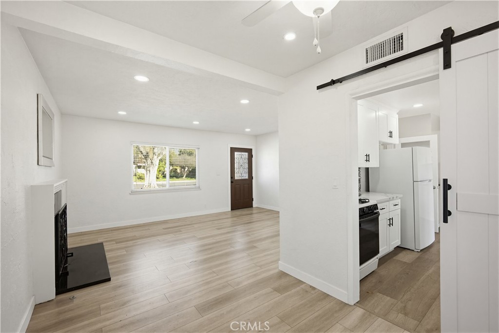 9805 Devon Street Rancho Cucamonga, CA 91730 - Photo 14 of 31 a view of a kitchen with a refrigerator a stove top oven and a refrigerator