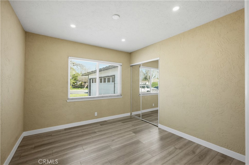 9805 Devon Street Rancho Cucamonga, CA 91730 - Photo 15 of 31 an empty room with wooden floor and a window