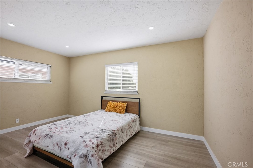 9805 Devon Street Rancho Cucamonga, CA 91730 - Photo 18 of 31 a bedroom with a bed and wooden floor