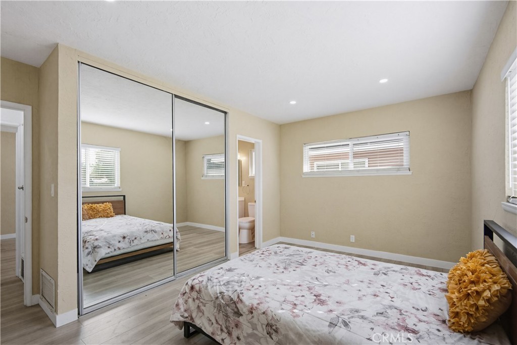 9805 Devon Street Rancho Cucamonga, CA 91730 - Photo 19 of 31 a bedroom with a bed and a mirror