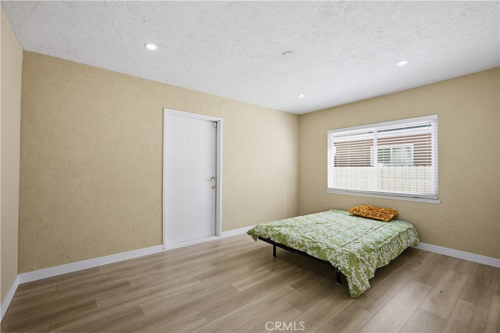 9805 Devon Street Rancho Cucamonga, CA 91730 - Photo 22 of 31 a bedroom with a bed and wooden floor