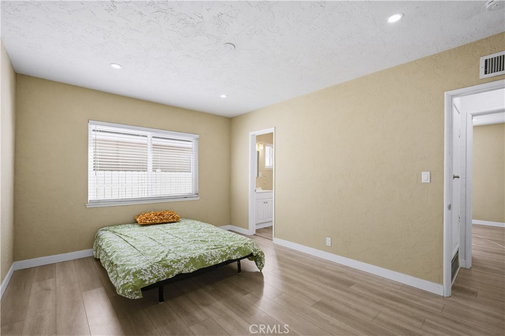 9805 Devon Street Rancho Cucamonga, CA 91730 - Photo 23 of 31 a bedroom with a bed and wooden floor
