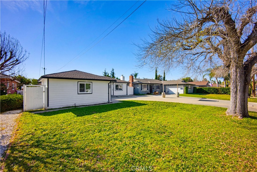 9805 Devon Street Rancho Cucamonga, CA 91730 - Photo 4 of 31 a view of a house with pool and a yard