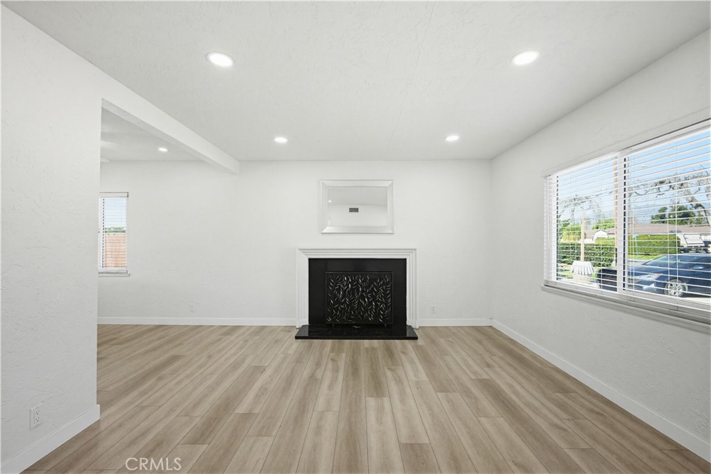 9805 Devon Street Rancho Cucamonga, CA 91730 - Photo 7 of 31 an empty room with wooden floor and windows
