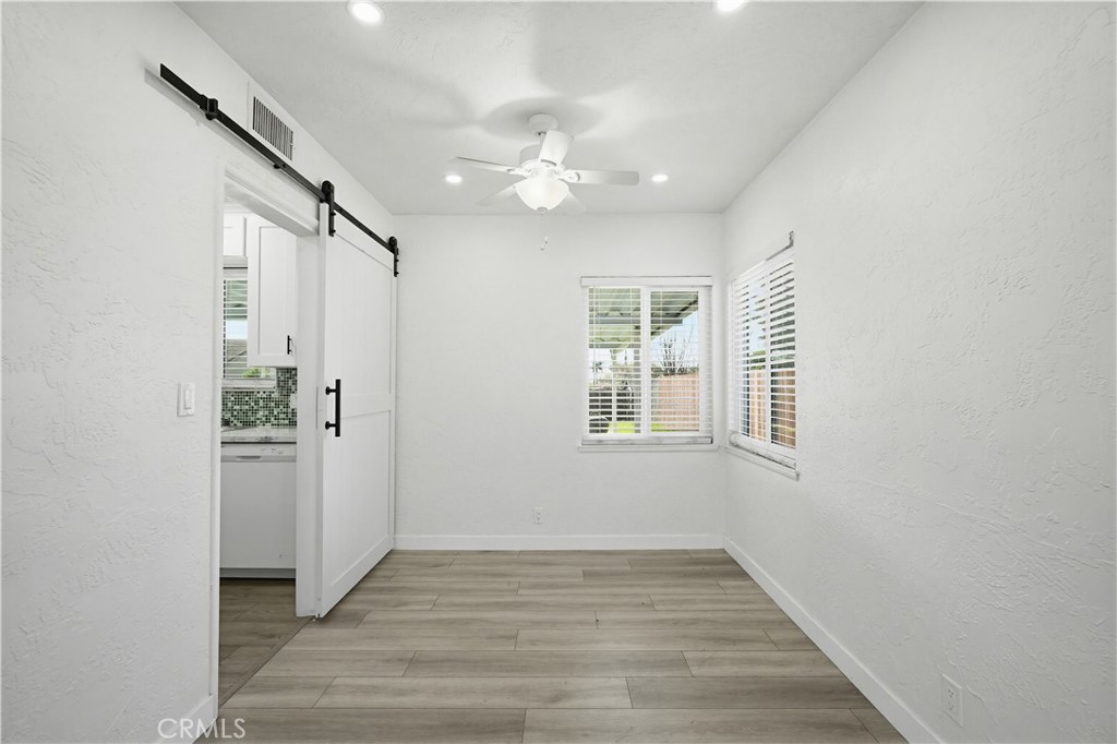 9805 Devon Street Rancho Cucamonga, CA 91730 - Photo 9 of 31 wooden floor in an empty room with a window
