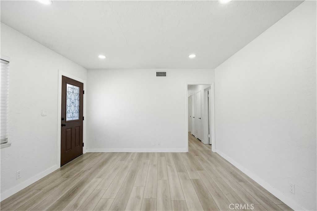 9805 Devon Street Rancho Cucamonga, CA 91730 - Photo 10 of 31 a view of an empty room with wooden floor and closet