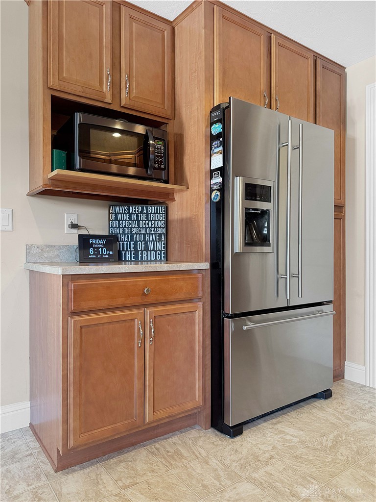4096 Middle Urbana Road Urbana, OH 43078 - Photo 39 of 96 This modern kitchen showcases elegant wooden cabinetry and contemporary stainless steel appliances.