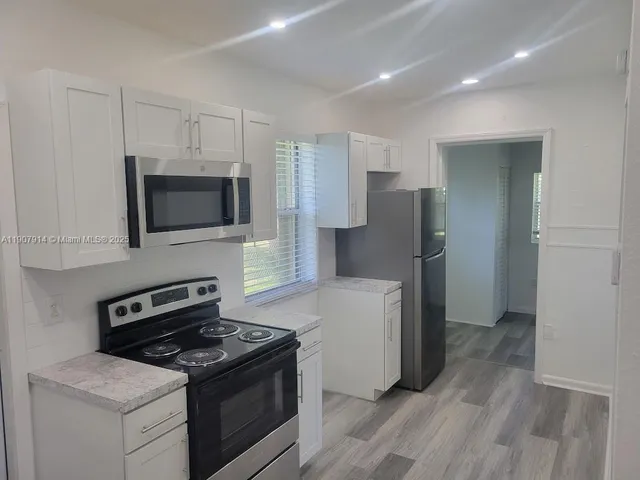 a kitchen with a stove and a refrigerator