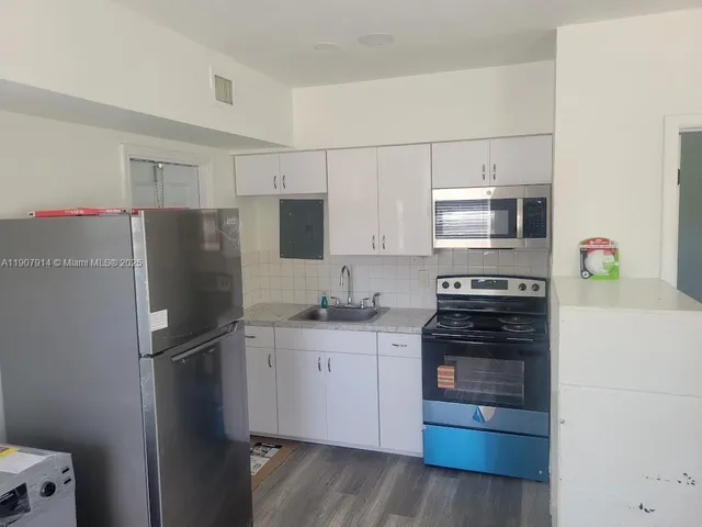 a kitchen with stainless steel appliances a refrigerator stove and microwave