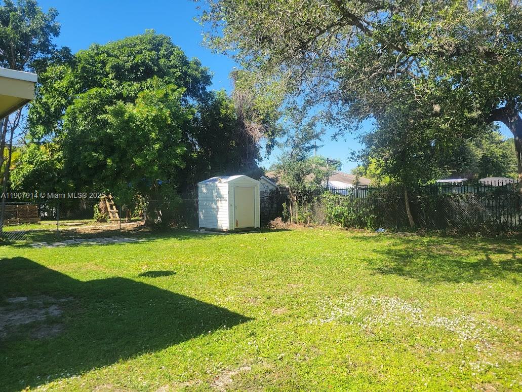 751 Northwest 96th Street Miami, FL 33150 - Photo 10 of 12 a backyard of a house with yard and trampoline
