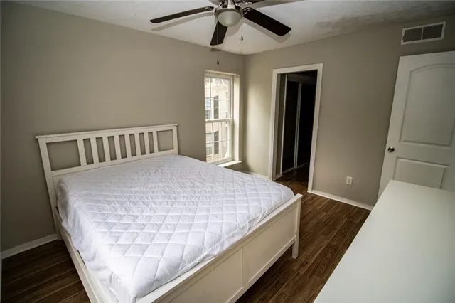 a bed sitting in a bedroom next to a window