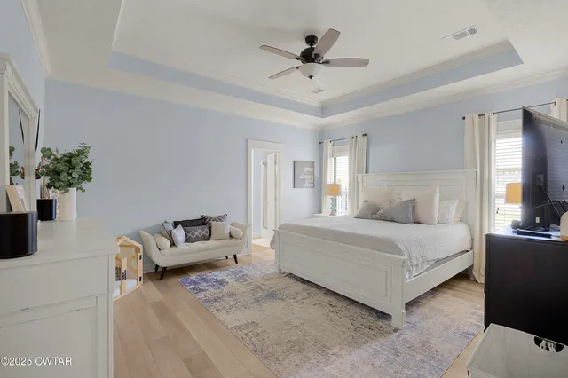 a spacious bedroom with a bed and a couch