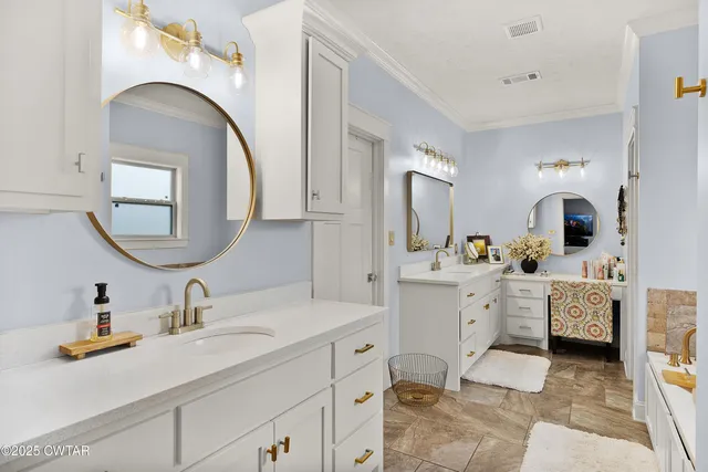 a spacious bathroom with a double vanity sink mirror and