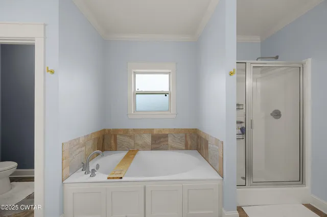 a bathroom with a tub sink and toilet