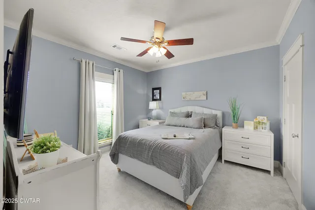 a living room with bed furniture and a chandelier