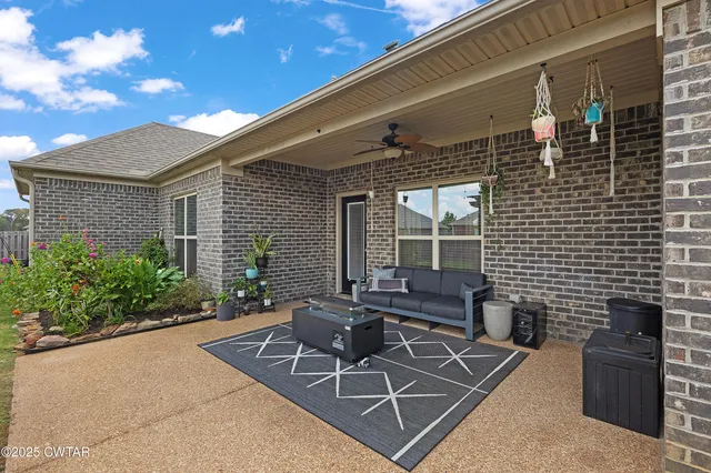 a building outdoor space with patio furniture and potted plants