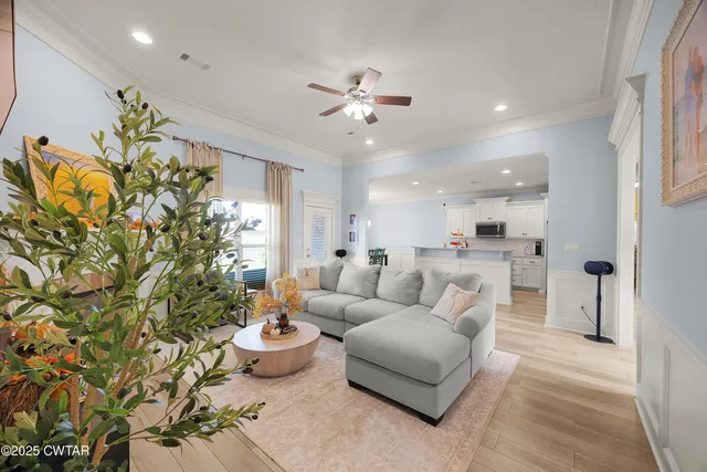 a living room with furniture and a chandelier