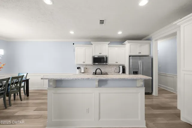 a view of kitchen with center island and stainless steel appliances