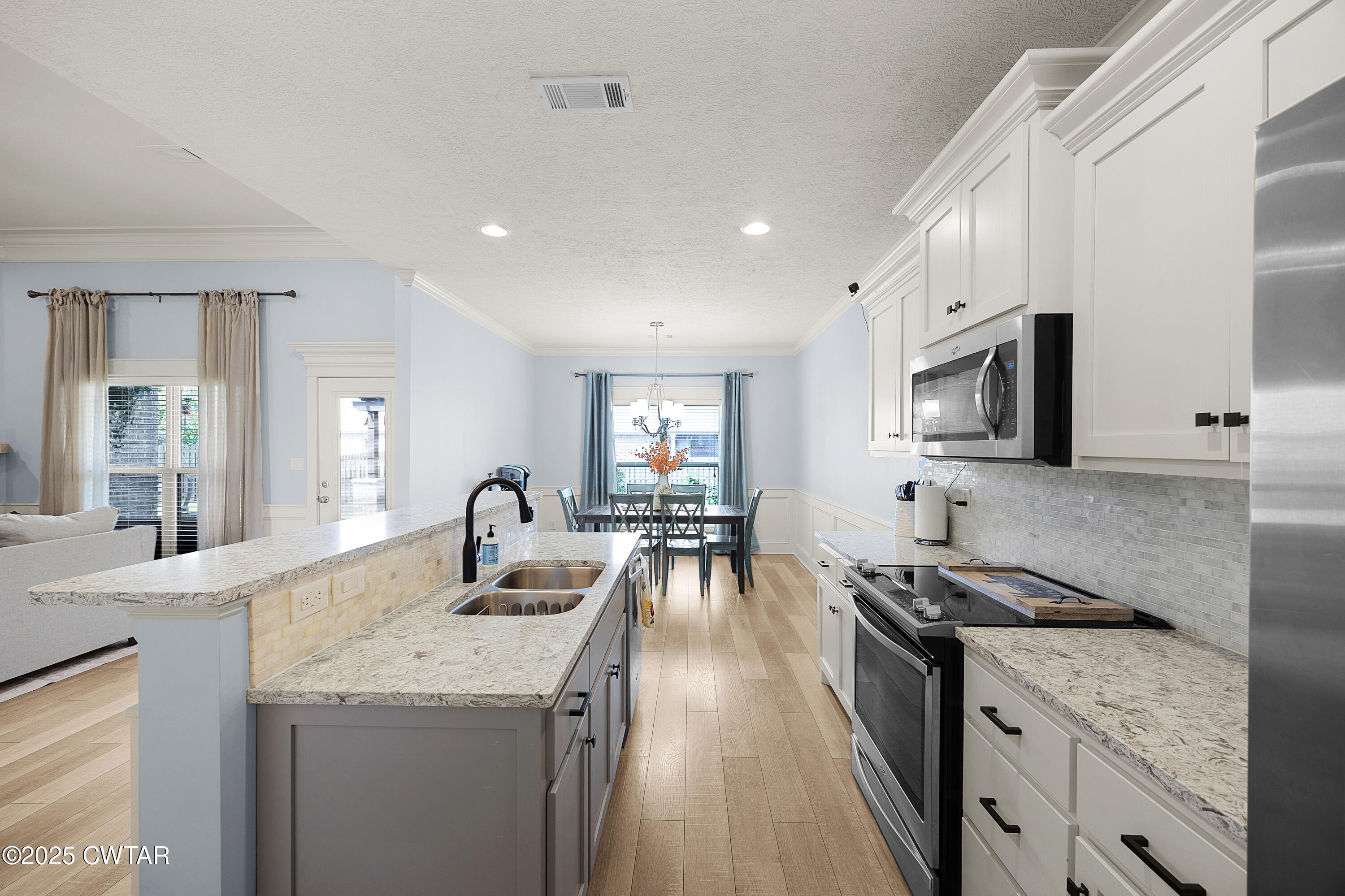 23 Shiloh Springs Jackson, TN 38305 - Photo 7 of 24 a kitchen with granite countertop a sink stove and cabinets