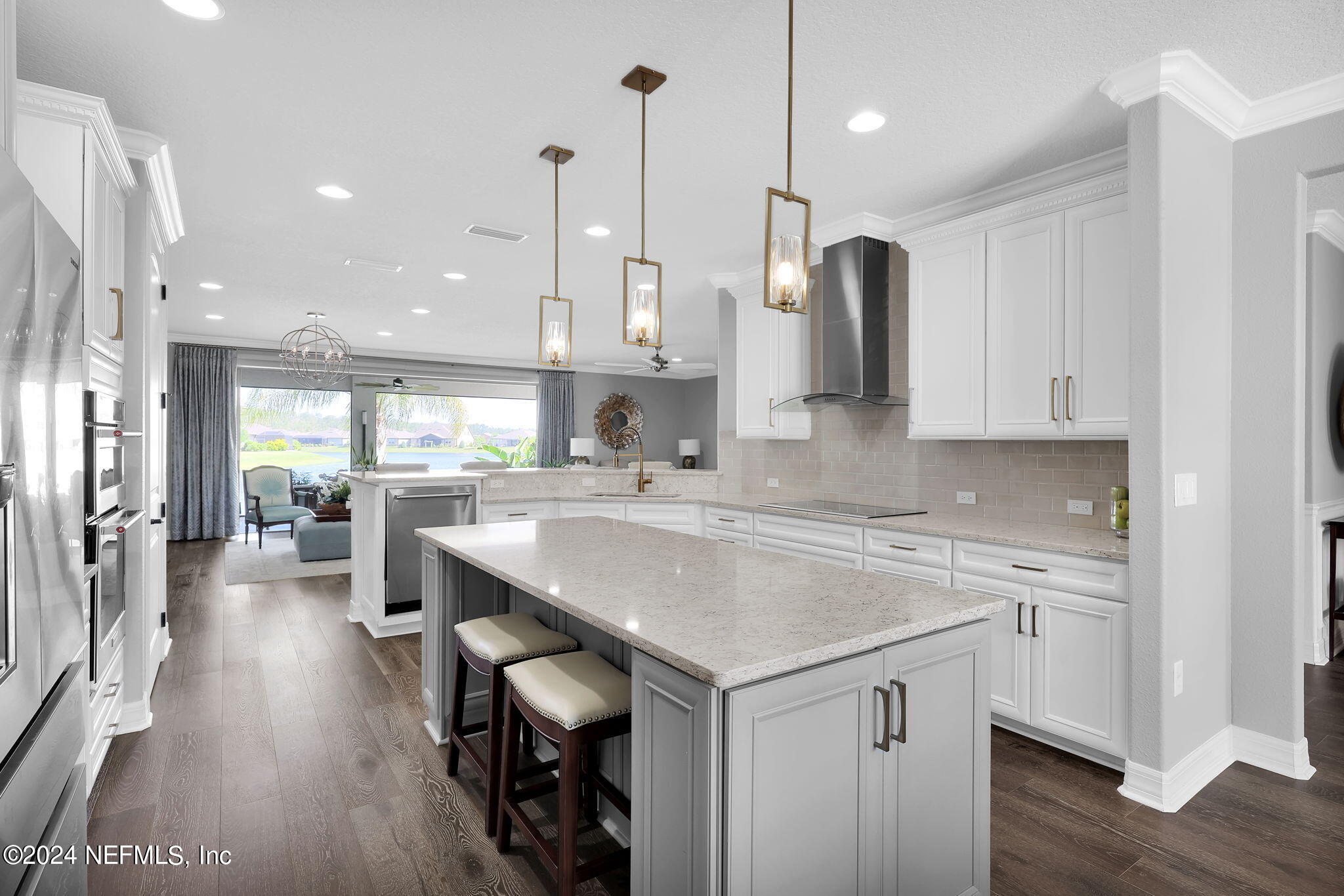 40 Tree Side Lane Ponte Vedra, FL 32081 - Photo 18 of 100 a kitchen with stainless steel appliances granite countertop a sink a stove a refrigerator and island with wooden floor