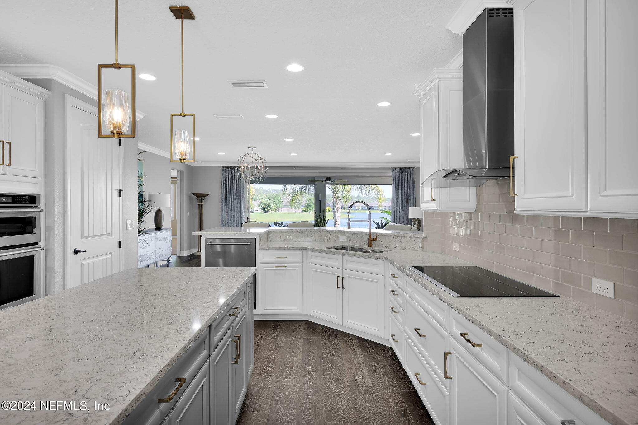 40 Tree Side Lane Ponte Vedra, FL 32081 - Photo 20 of 100 a kitchen with stainless steel appliances granite countertop sink stove and white cabinets with wooden floor