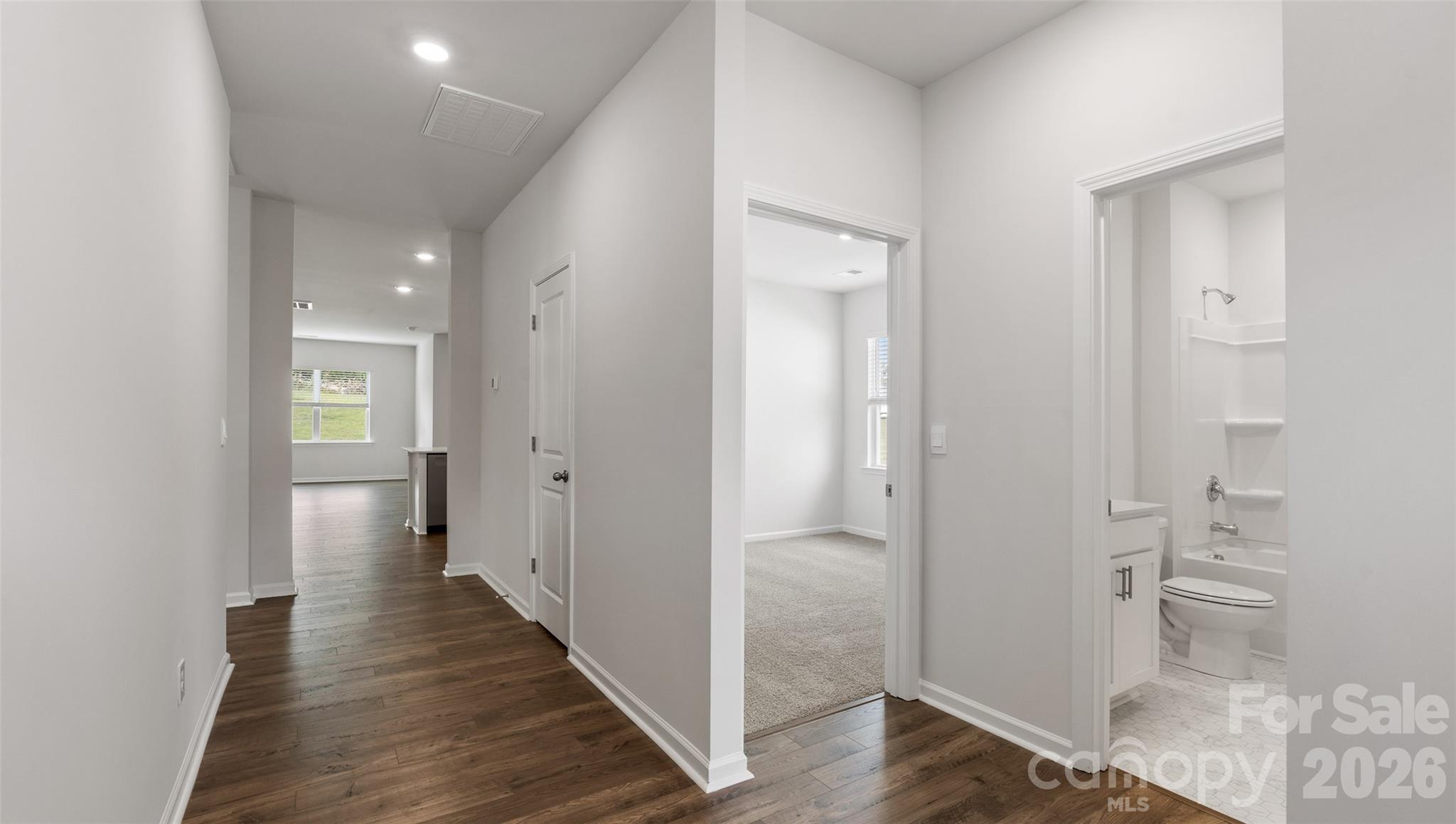 100 Piney Wds Road Fletcher, NC 28732 - Photo 5 of 33 a view of a hallway with wooden floor and a bathroom