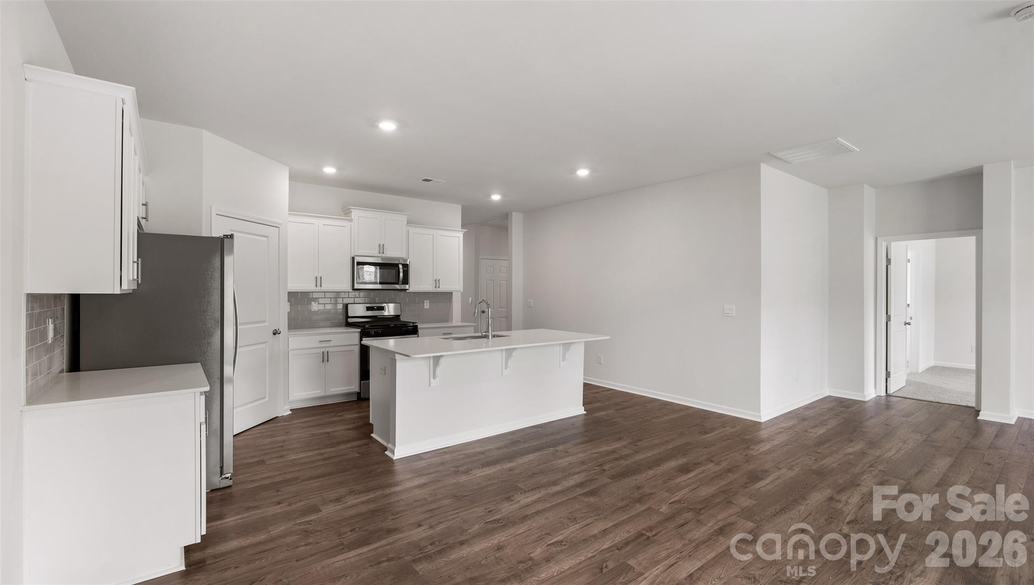 100 Piney Wds Road Fletcher, NC 28732 - Photo 6 of 33 a kitchen with a refrigerator and a stove top oven