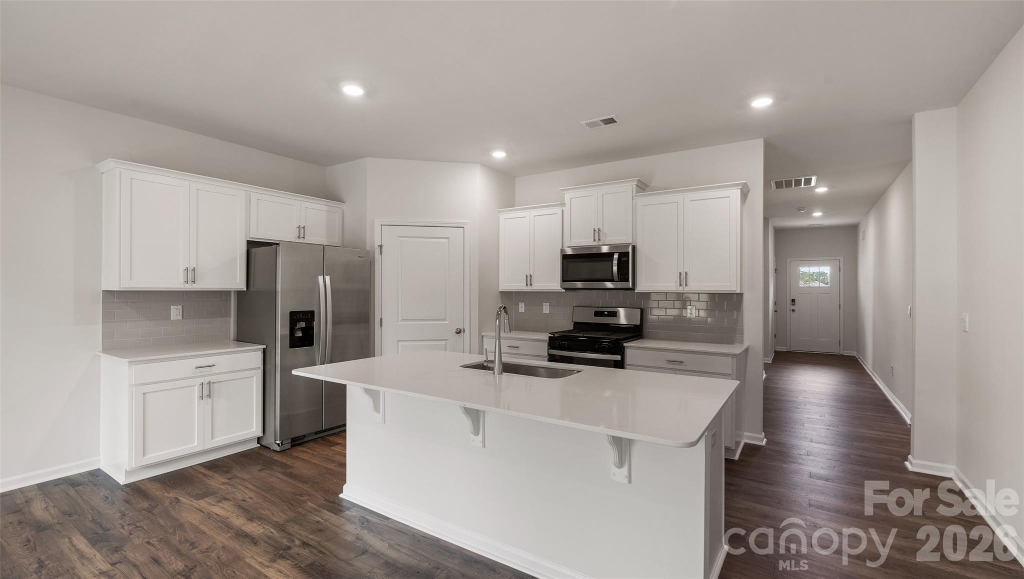 100 Piney Wds Road Fletcher, NC 28732 - Photo 8 of 33 a kitchen with refrigerator a stove and cabinets