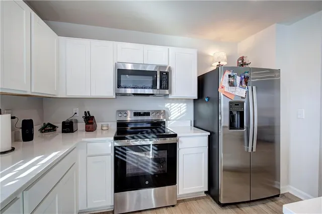 a kitchen with a stainless steel appliances and cabinets