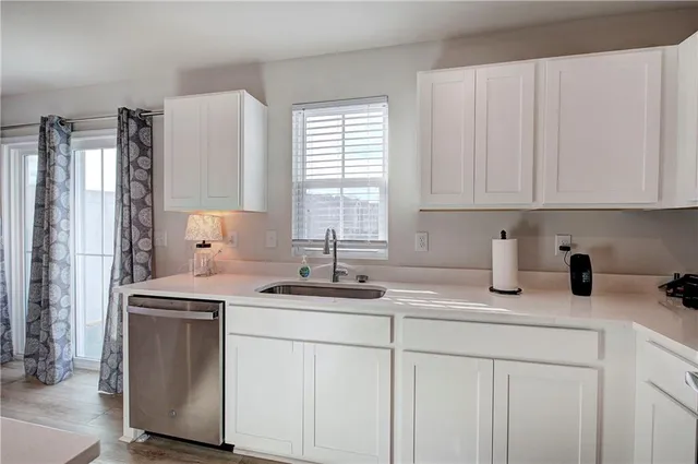 a kitchen with stainless steel appliances granite countertop a sink stove and cabinets