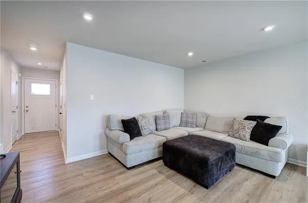 a living room with furniture and wooden floor