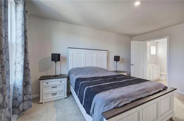 a bedroom with a bed and two night stand