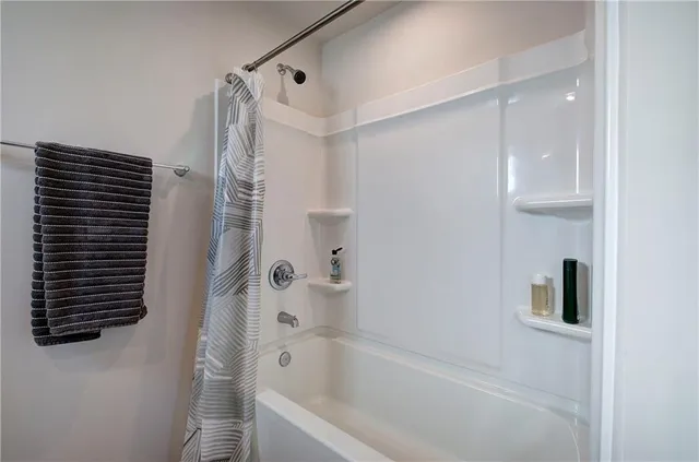 a bathroom with a bathtub and a shower