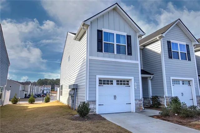 a view of a house with a yard and sitting area