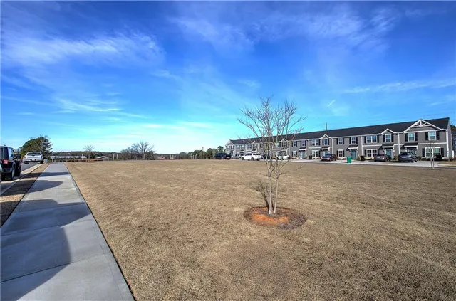 a view of swimming pool with a yard and lake view