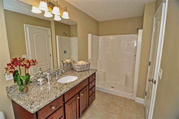 59 Partridge Hill Road Sutton, MA 01590 - Photo 14 of 16 a bathroom with a granite countertop shower a sink and a mirror