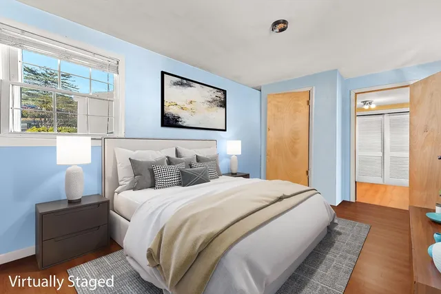 a bedroom with bed and a window