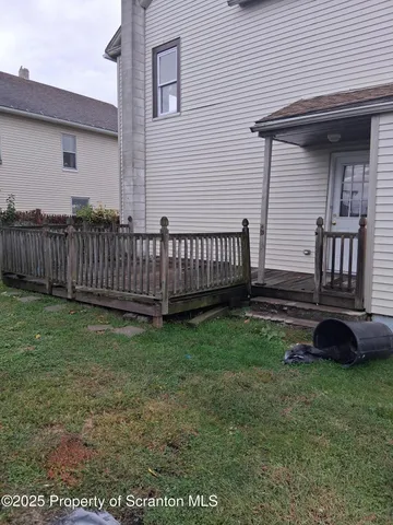 a view of a house with backyard and deck