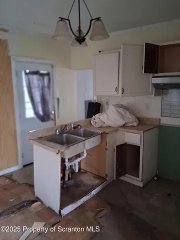 a kitchen with stainless steel appliances granite countertop a sink a stove a microwave and cabinets