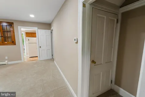 a kitchen with sink refrigerator and cabinets