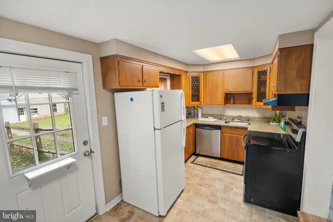 a kitchen with stainless steel appliances a sink stove and cabinets
