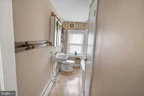 a bathroom with a sink a toilet and tub