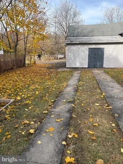 a view of yard with large trees