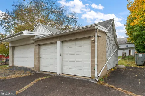 a view of small house with a garage