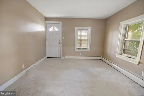 an empty room with windows and closet